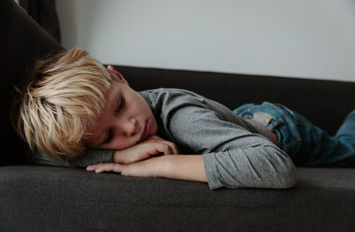 depressed child on couch for post about supporting children's/kids' mental health